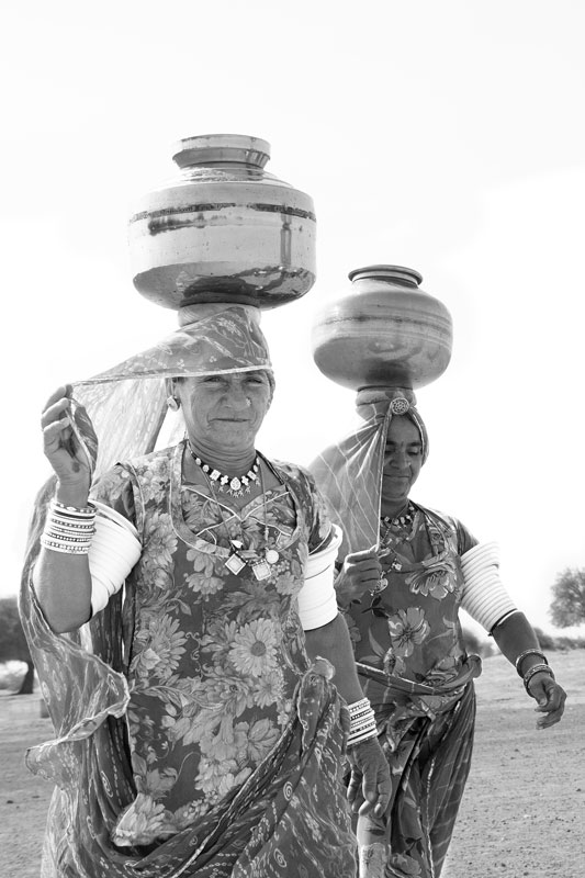 Water portraits - Returning to village with water from 'beri' (small shallow drinking water well) in the Thar Desert – Jaisalmer district, Rajasthan